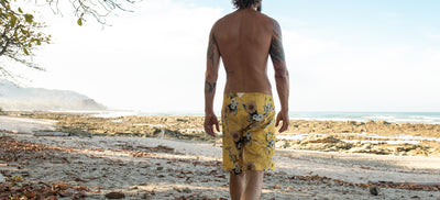 Man wearing Blighty shorts on the beach