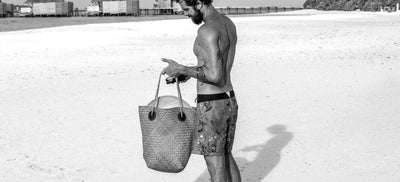 Man wearing Burgh shorts on the beach
