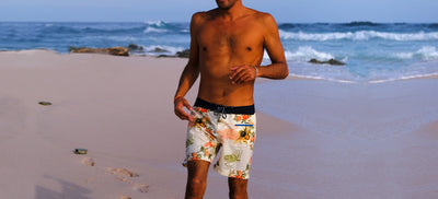 Man wearing Burgh shorts on the beach